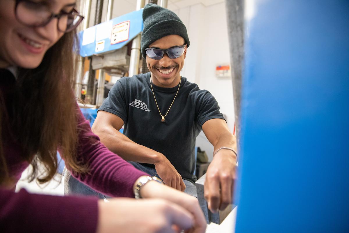 Image is of a student working with a teacher.